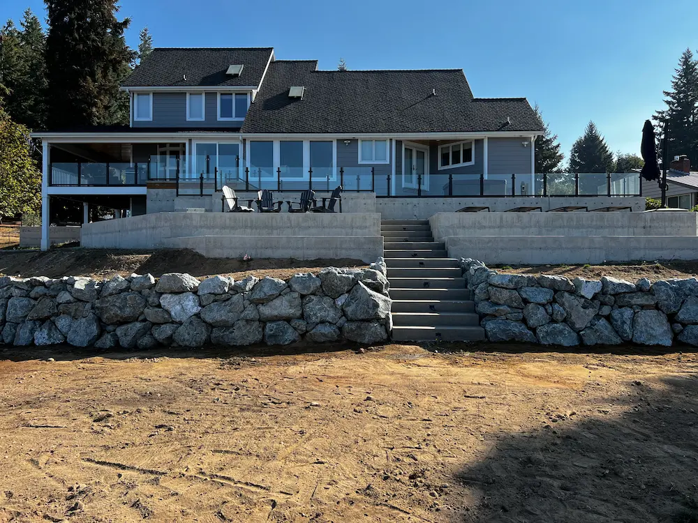 Hardscape wall installtion in front of a house completed by Variant Construction.